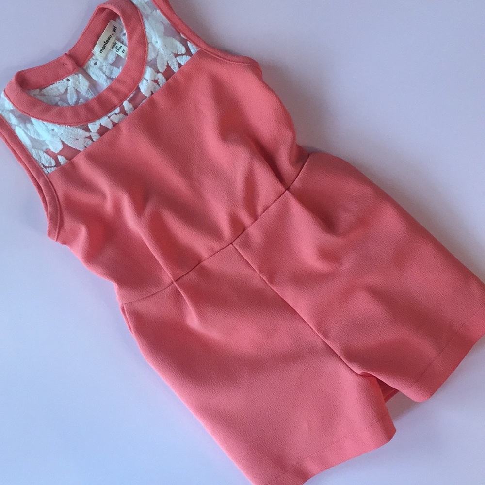 Peachy orange romper with lace detailing.